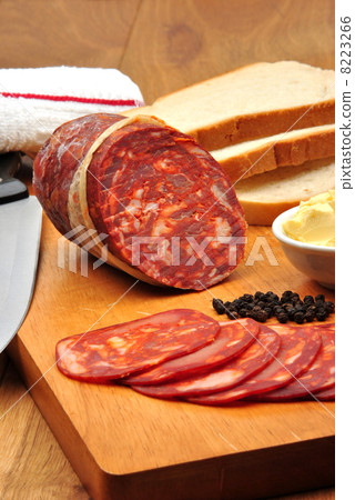 chorizo salami and some slices salami on a timber board chorizo salami and some slices salami on a timber board 8223266