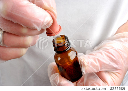 Health care staff with disposable gloves and pipette Health care staff with disposable gloves and pipette 8223689