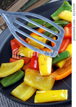sliced ??and grilled organic peppers on a pan sliced ??and grilled organic peppers on a pan 8224209