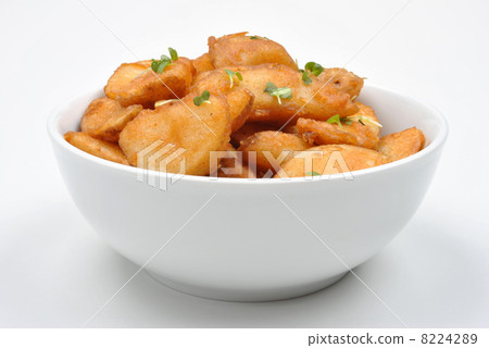some fried potato wedges in a bowl 8224289