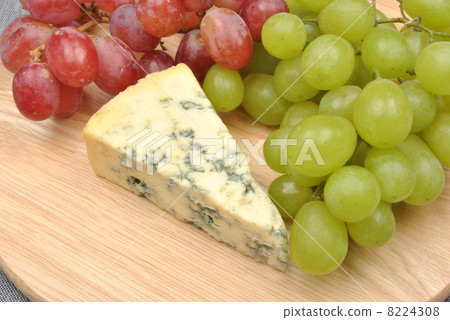 home made cheese with grapes in the background 8224308