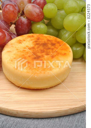 home made cheese with grapes in the background home made cheese with grapes in the background 8224373