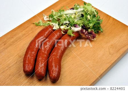 smoked sausage and organic gherkin on a timber board smoked sausage and organic gherkin on a timber board 8224401