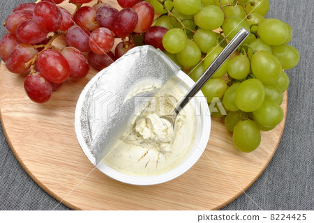 home made cheese with grapes in the background home made cheese with grapes in the background 8224425
