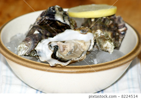 some organic oyster and lemon in a bowl some organic oyster and lemon in a bowl 8224514