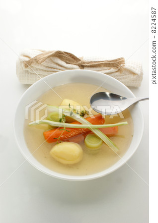 delicious vegetable soup in a white bowl with a spoon 8224587