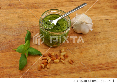 fresh pesto and garlic on a timber board 8224741