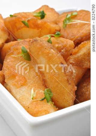some fried potato wedges in a bowl some fried potato wedges in a bowl 8224790
