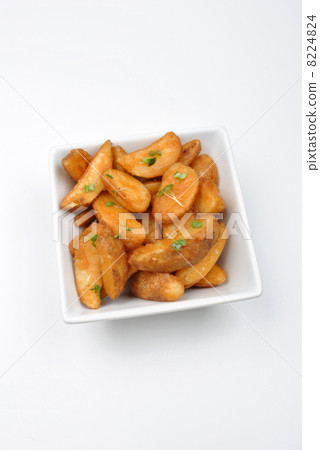 some fried potato wedges in a bowl 8224824