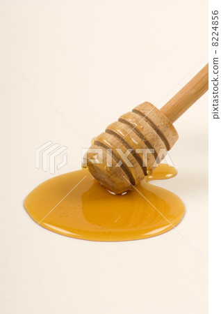 a honeyspoon and some sweet organic honey 8224856