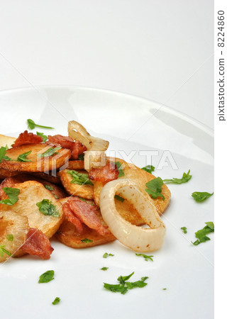 roasted potato with organic onion on a white plate roasted potato with organic onion on a white plate 8224860