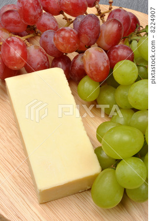home made cheese with grapes in the background 8224907