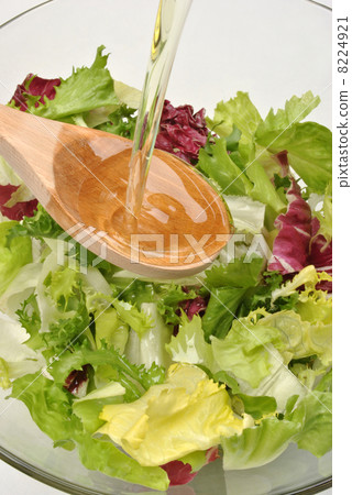 organic salad in a bowl with vegetable oil 8224921