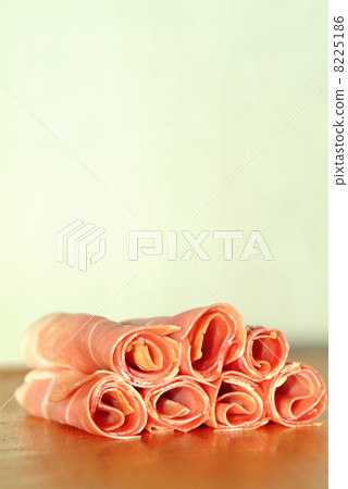 sliced ham rolled on a timber plate sliced ham rolled on a timber plate 8225186