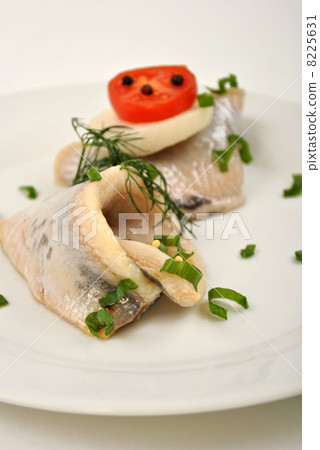 some fresh organic herring on a white plate some fresh organic herring on a white plate 8225631