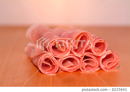sliced ham rolled on a timber plate sliced ham rolled on a timber plate 8225641