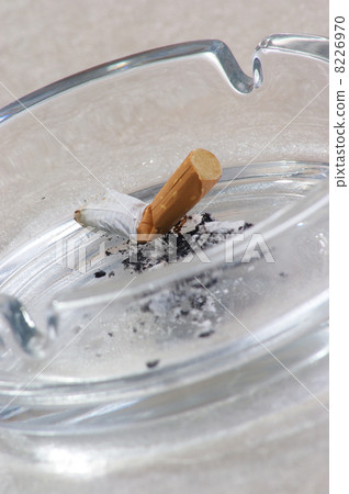 one unhealthy cigarette in a glass ashtray 8226970