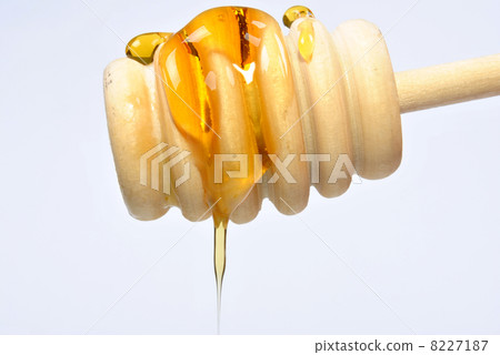 a honey spoon and some sweet organic honey a honey spoon and some sweet organic honey 8227187