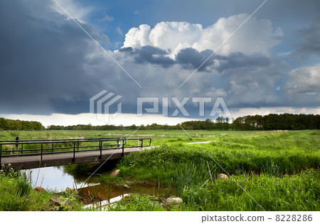 bridge over river and stormy clouds 8228286