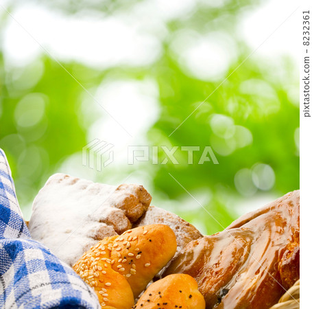 Basket of buns on green leaves background Basket of buns on green leaves background 8232361