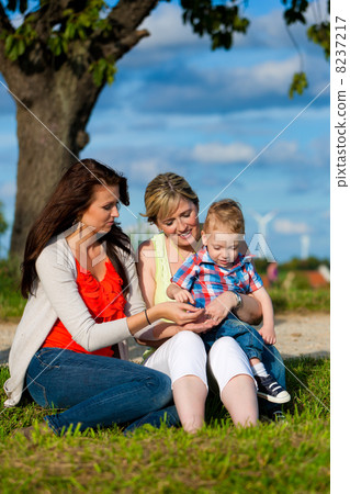 Family - Grandmother, mother and child in garden 8237217