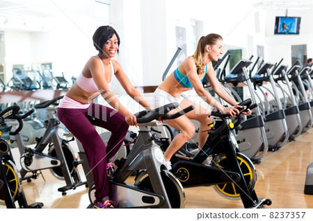People Spinning in the gym on bicycles 8237357