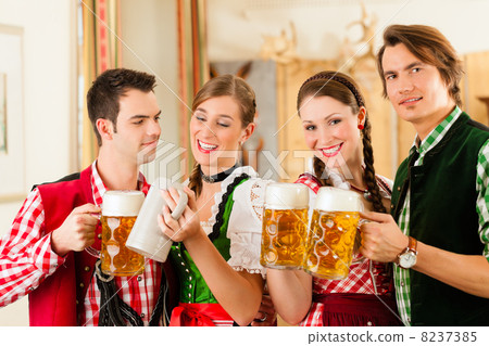 Young people in traditional Bavarian Tracht in restaurant or pub Young people in traditional Bavarian Tracht in restaurant or pub 8237385