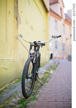 Old-fashioned bike on a street Old-fashioned bike on a street 8237585