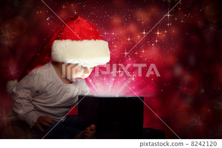 happy baby child girl in Christmas hat opening a magic gift box happy baby child girl in Christmas hat opening a magic gift box 8242120