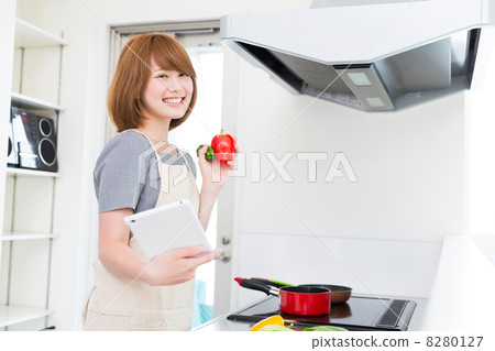 烹調的婦女,當觀看片劑時 烹調的婦女,當觀看片劑時 8280127