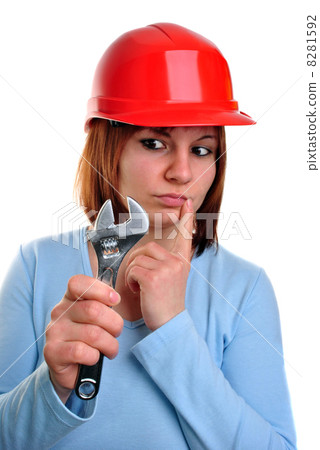 young woman with helmet holds a socket wrench 8281592