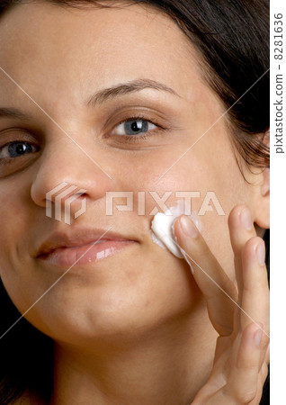 young woman put on some hydrating cream 8281636