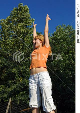 Girl Jumping on Trampoline Girl Jumping on Trampoline 8282424