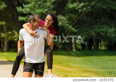 Boyfriend giving piggyback ride to girlfriend 8285370