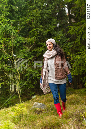 Happy woman walking in autumn forest Happy woman walking in autumn forest 8285387