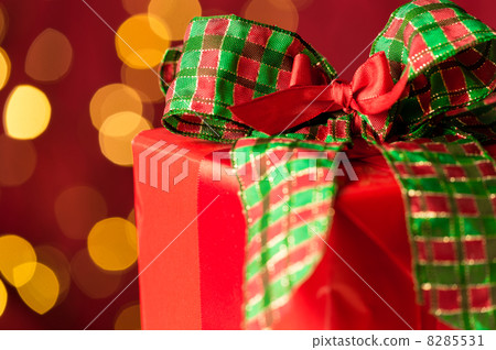 Christmas gift and sparkling lights in background Christmas gift and sparkling lights in background 8285531