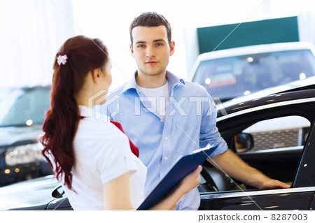 Young man at car salon 8287003
