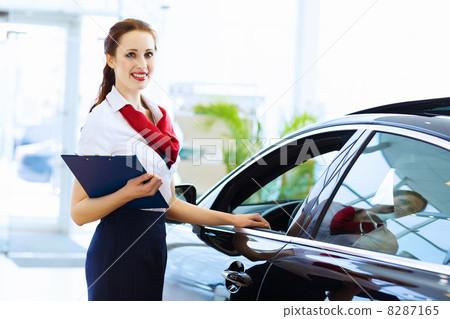 Woman consultant at car salon Woman consultant at car salon 8287165