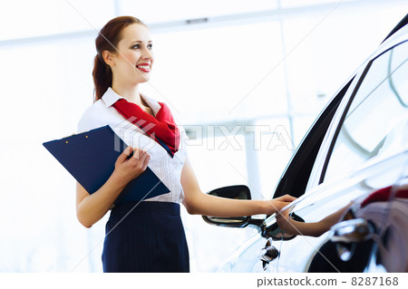 Woman consultant at car salon Woman consultant at car salon 8287168