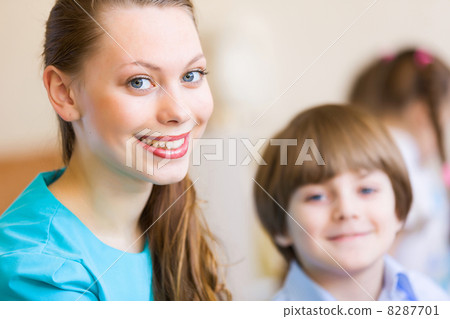 Children painting with teacher Children painting with teacher 8287701