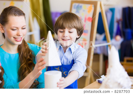 Children painting with teacher Children painting with teacher 8287703