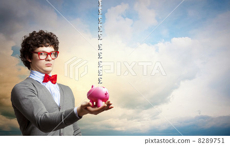 Young businessman holding moneybox 8289751
