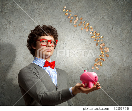 Young businessman holding moneybox Young businessman holding moneybox 8289756