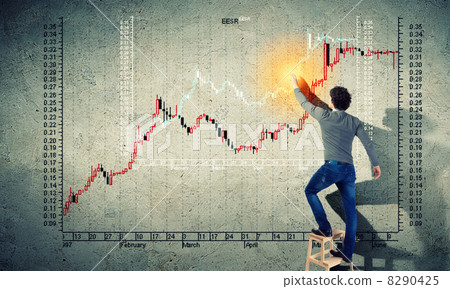 Young man drawing a graph on the wall 8290425