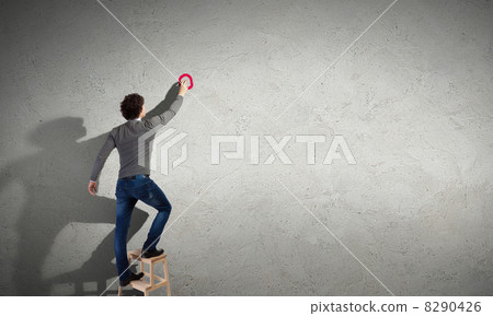 Young man standing near the wall Young man standing near the wall 8290426