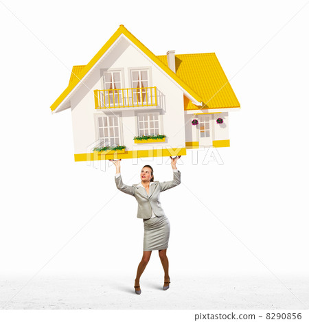 Businesswoman holding model of house Businesswoman holding model of house 8290856