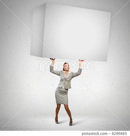Businesswoman holding heavy cube Businesswoman holding heavy cube 8290865