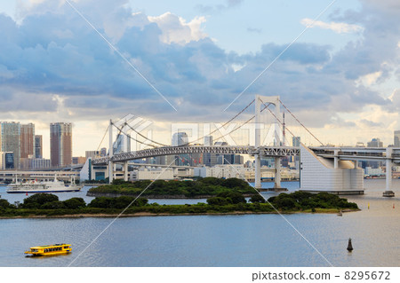 A rainbow bridge and a houseboat in Odaiba Seaside Park at dusk A rainbow bridge and a houseboat in Odaiba Seaside Park at dusk 8295672