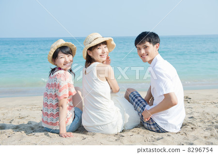 Young men and women sitting on the beach Young men and women sitting on the beach 8296754