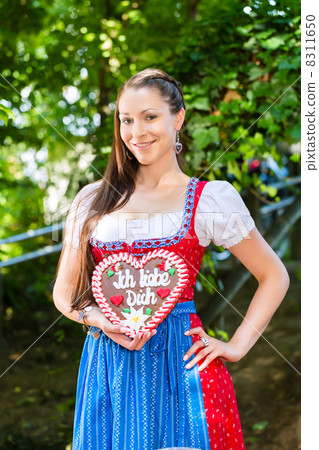 Woman with gingerbread hart in Bavaria beergarden 8311650